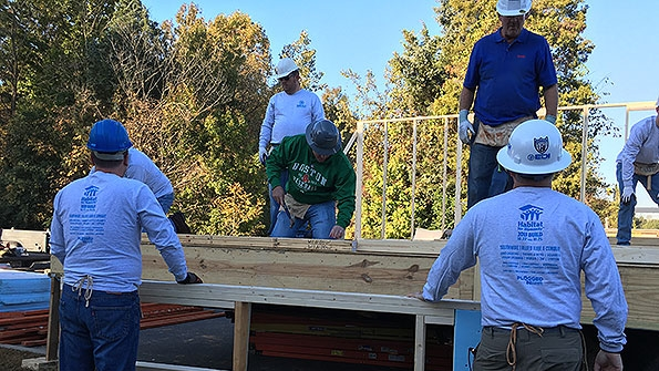 A hundred associates from Shealy Electrical Wholesalers built a home for Habitat for Humanity in the parking lot of its Charlotte NC location and transported it to a neighborhood three miles away