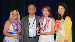 Angie Prost (left), Lighting One product and supplier manager; Fred Farzan, Nora Lighting CEO and president; Jilla Farzan, Nora Lighting executive vice president; and Madie Young, Lighting One marketing associate.