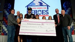 U.S. Army Specialist Hugo Gonzalez, his family, and Andy Pujol, president and founder of Building Homes for Heroes, accept Legrand&rsquo;s initial donation during the annual sales meeting. Attendees were so moved by Specialist Gonzalez&rsquo;s speech that an additional $4,000 was raised after the check presentation ceremony.