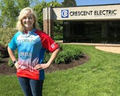 Abby Bertsch, Crescent Electric&apos;s industry marketing manager, promoting one of the custom jerseys the company is supplying for 50 lucky riders participating in Iowa&apos;s famed RAGBRAI bike tour.