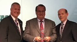 Michael W. Pessina, president, Lutron (left); and Kevin Cosgriff, NEMA&rsquo;s president and CEO (right): present Goren Haag, founder Champion Fiberglass, with the BIC Award.