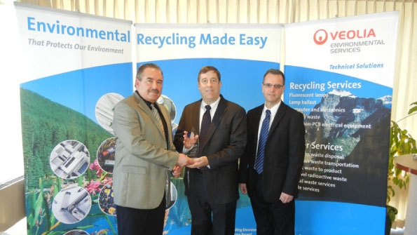 Fred Ribelli Veolia environmental account manager left and Kevin Shaver Veolia environmental operations manager right presented Veoliarsquos Environmental Stewardship Award to Jack Schmid Crescent Electric Supply product and inventory manager