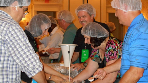 More than 250 Schneider Electric employees and distributors took a break from training to package meals for Stop Hunger Now