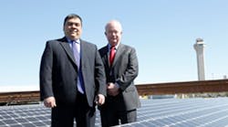 Jim Heitmann, acting general manager of Newark Liberty International Airport and Michael Gibson, vice president for energy services at ConEdison Solutions, atop one of Newark Liberty International Airport&apos;s four solar rooftops.