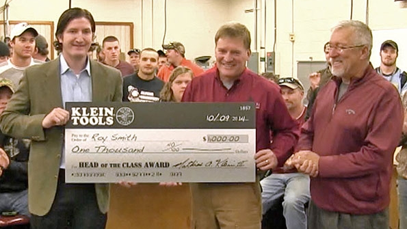 Roy Smith center of the Alpena College Utility Technology Program in Alpena Mich was selected as Klein Tools39 Head of the Class instructor of the year accepting the award from Tom Barton right and Len Swiatek of Klein Tools