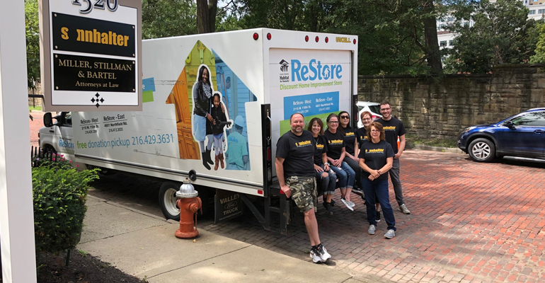 Sonnhalter team members poses by a Habitat truck.