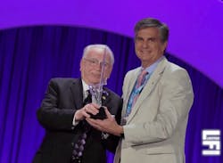 Randy Reid (right) receives an Innovative Product Award from LightFair International in 2018 for LumEfficient&rsquo;s LiFi-enabled product.
