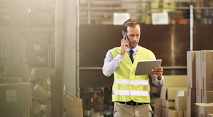 Dist Man Using A Tablet In Warehouse